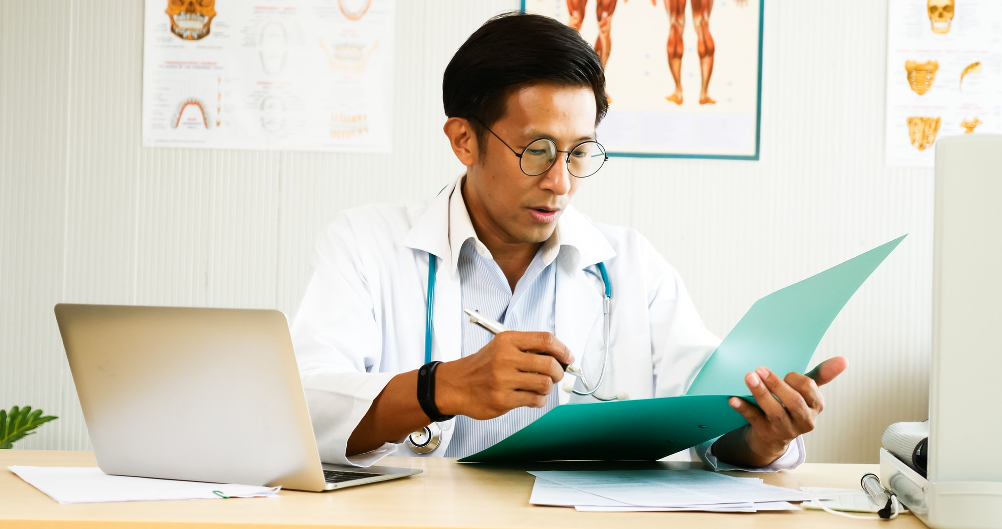 Doctor checking diagnosis results at doctor's room.